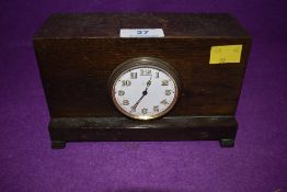 An early 20th century bedside clock, having 8 day Swiss movement. Mounted in an oak case
