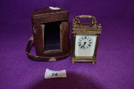 A small Victorian brass travel/bedroom carriage clock having bevelled glass panels to all four sides