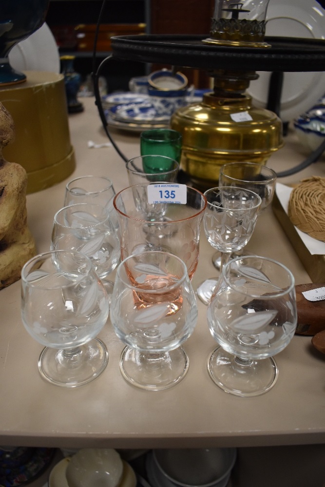 A collection of vintage glasses, including etched brandy or similar with folded foot, green