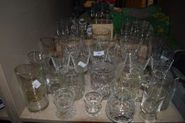 A collection of glass including Guinness glasses, tankards and wine glasses.