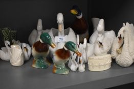 A collection of ceramic ducks and swans.