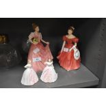 Two Royal Doulton figurines, and two smaller Coalport ones.