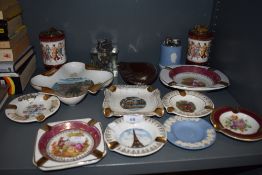 A variety of vintage desktop lighters and ash trays, a lot having floral designs, some tourist