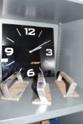A black glass clock and three grab handles or similar.