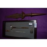 A cased warriors miniature ceremonial sword and Indian styled dagger with chased copper handle.
