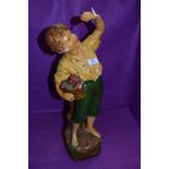 An early 20th Century plaster figure modelled as fruit picking boy (Cherry boy) , some damage and