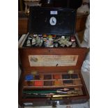 A vintage mahogany boxed Reeves and Woodyer paint set,a similar tin of paints and a palette.