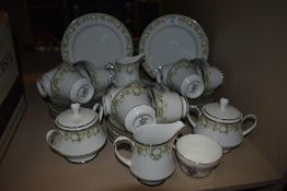 A part Noritake dinner service having muted green floral transfer pattern and silver gilt edging,