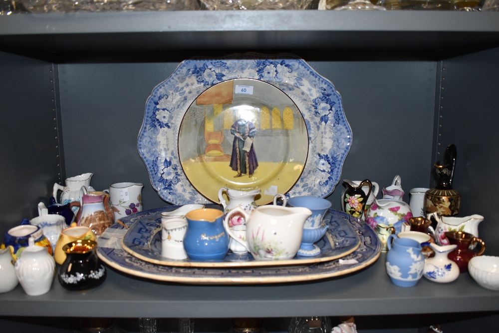 A large collection of jugs, including Wedgewood and some souvenir items, also three large platters