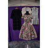 Three vintage 1950s dresses and a blouse, two cotton dresses, one having pink flowers on a grey