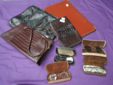 A variety of vintage handbags, including reptile and a selection of 1930s reading glasses in cases.