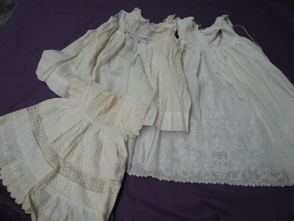 Two antique embroidered Childrens gowns, two tulle bonnets and apron,incredibly fine detail to these