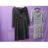 Two vintage 1950s dresses, one of black wool with Sylvia Mills label, the other in gold,navy and