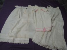 A lot of five antique baby gowns and dresses, some beautiful lace work and cutwork throughout.