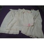 A lot of five antique baby gowns and dresses, some beautiful lace work and cutwork throughout.