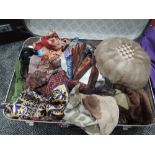 A suitcase full of vintage and retro gloves, scarves and a mink hat.