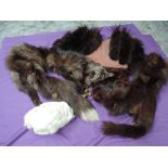 A collection of fur, including two fox fur stoles, mink hat and more.