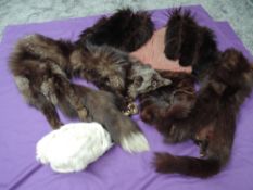 A collection of fur, including two fox fur stoles, mink hat and more.