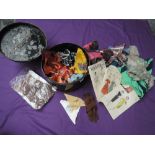 A metal sailors hat tin containing an assortment of 50s dress patterns, stockings,scarves and