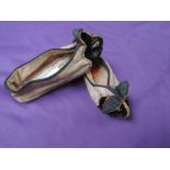 A pair of vintage children's slippers or shoes having oriental styling and rabbit faces to toes in