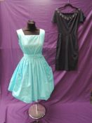 Two 1950s dresses, one having large feature pockets to front, pleated skirt and belt the second