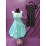 Two 1950s dresses, one having large feature pockets to front, pleated skirt and belt the second