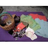 A basket full of vintage and antique items including costume jewellery, handkerchiefs and case,