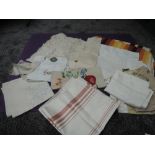 A selection of vintage table cloths,huckaback towels, mats and more,included are embroidered items