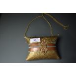 An ornate vintage brass and copper embossed evening bag or similar.having clasp fastening to front
