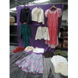 A large collection of women's mixed vintage clothing, including four knitted dresses, a Laura Ashley