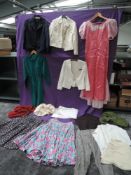 A large collection of women's mixed vintage clothing, including four knitted dresses, a Laura Ashley