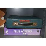 An Olivette typewriter and boxed film adaptor
