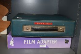 An Olivette typewriter and boxed film adaptor