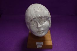 An interesting studio pottery ceramic modelled as a girls head