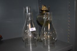 A glass bodied oil lamp and flutes