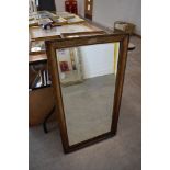 A mantle mirror having bevel edged glass with gilt and plaster frame