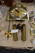 A brass faced long case clock mechanism stamped Tempus Fugit