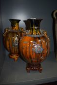 A pair of oriental possibly Japanese mantle vase or urns with three footed base and character seal