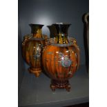 A pair of oriental possibly Japanese mantle vase or urns with three footed base and character seal