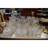 A selection of clear cut and crystal glass wares including water jug and large etched fruit bowl