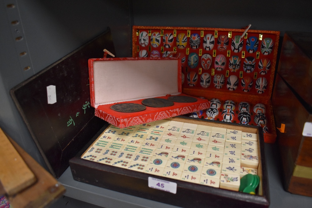 A selection of Chinese games and counters including miniature mask set and boxed Ma Jong