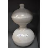 A vintage stone ware studio pottery vessel or lamp base with white glaze and gourd design