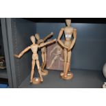 A selection of beech wood artist poseable figures and models
