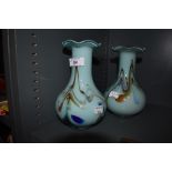 Two coloured glass vases with mottled blue and orange swirls