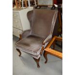 A vintage Parker Knoll wing back armchair
