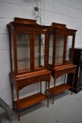 A pair of reproduction yew wood display cabinets, illuminated upper glazed section over double