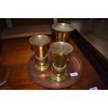 A set of three solid brass cast communion or similar service chalice