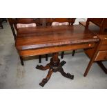 A William IV Rosewood fold over tea table, hollow section under top, on central turned column over