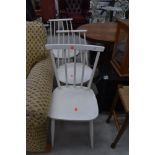 A set of three vintage painted kitchen chairs having rail and stick backs, in the Ercol style