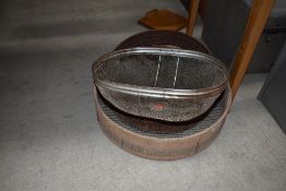 Two vintage soil sieves, two flat irons and a meat or cake cover